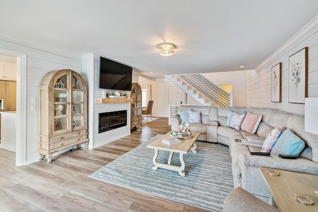144 Tanasi Shr, Gallatin, TN 37066 - living room with stairway, ornamental molding, a glass covered fireplace, and wood finished floors