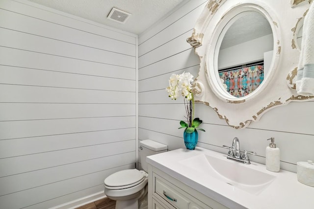 144 Tanasi Shr, Gallatin, TN 37066 - bathroom featuring vanity, wood finished floors, visible vents, a textured ceiling, and toilet