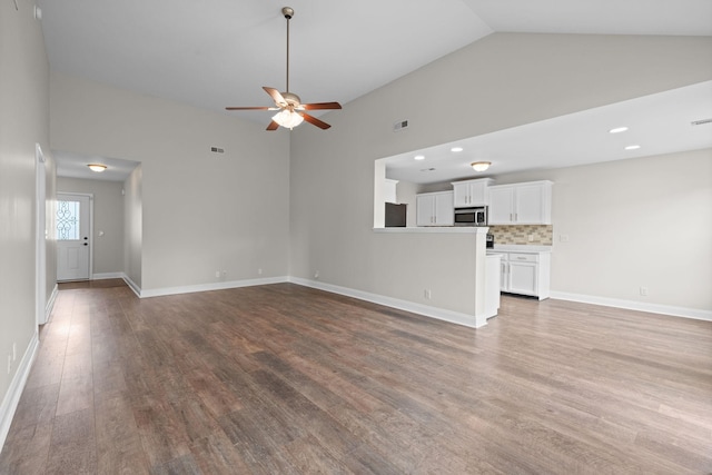 568 Tracy Ln, Clarksville, TN 37040 - unfurnished living room featuring wood finished floors, a ceiling fan, recessed lighting, and high vaulted ceiling
