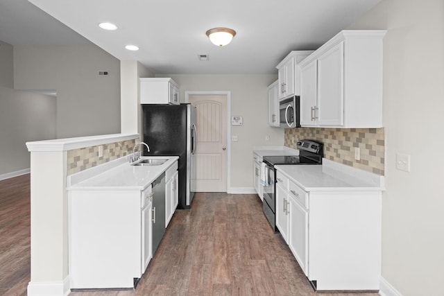 568 Tracy Ln, Clarksville, TN 37040 - kitchen featuring stainless steel appliances, backsplash, wood finished floors, light countertops, and white cabinets