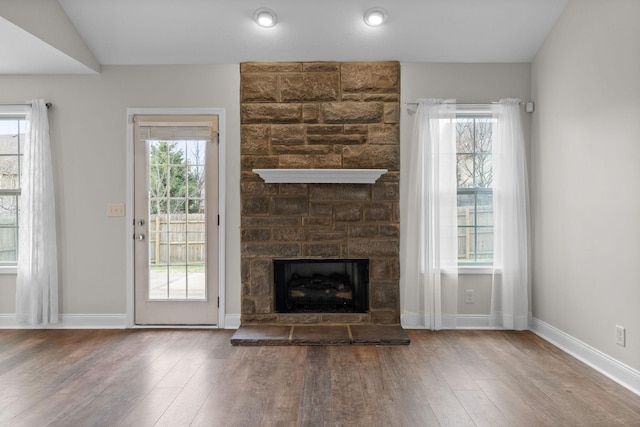 568 Tracy Ln, Clarksville, TN 37040 - unfurnished living room featuring hardwood / wood-style floors, healthy amount of natural light, and a stone fireplace