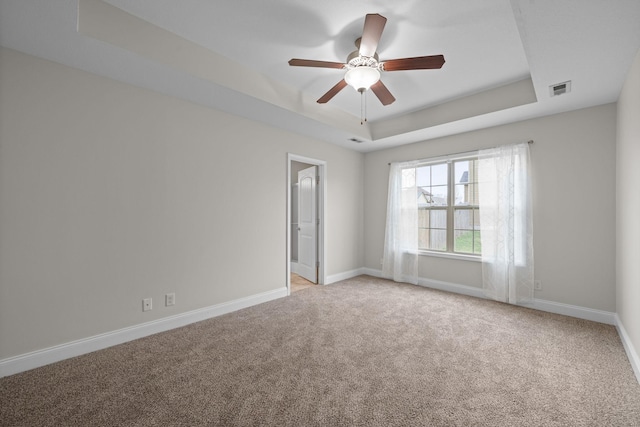 568 Tracy Ln, Clarksville, TN 37040 - spare room with a tray ceiling, a ceiling fan, and light carpet