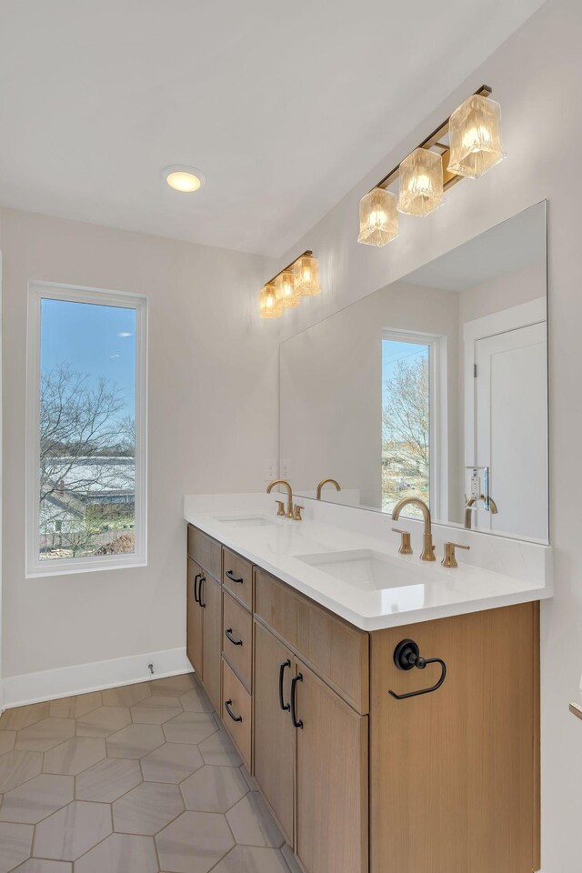 1016 W Kirkland Ave Unit C, Nashville, TN 37216 - bathroom featuring double vanity, baseboards, and a sink