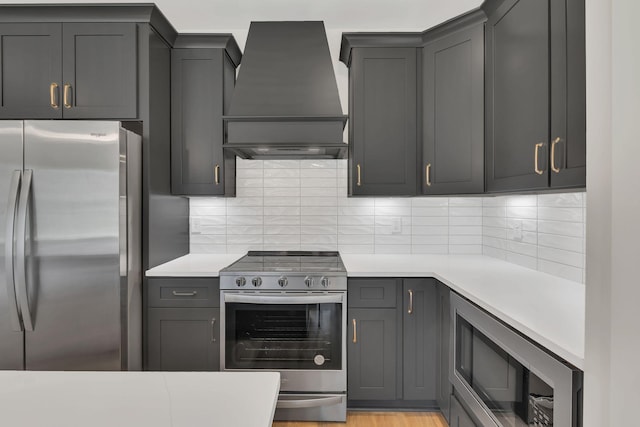 1016 W Kirkland Ave Unit C, Nashville, TN 37216 - kitchen featuring decorative backsplash, custom exhaust hood, light countertops, and appliances with stainless steel finishes