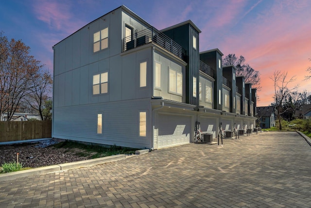 1016 W Kirkland Ave Unit C, Nashville, TN 37216 - view of side of property featuring central AC, a balcony, an attached garage, and driveway