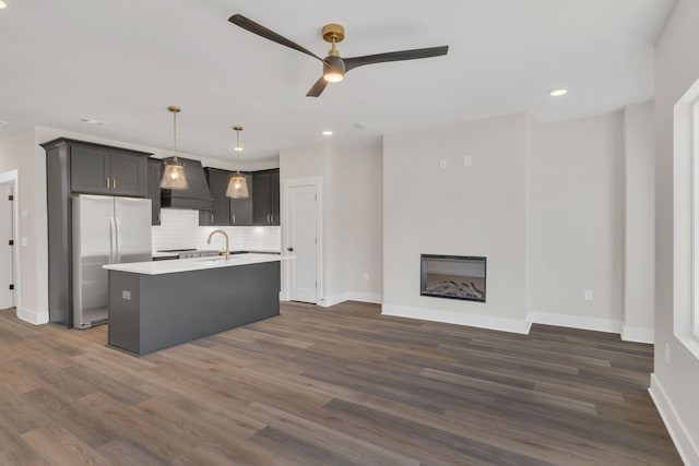 1016 W Kirkland Ave Unit C, Nashville, TN 37216 - kitchen featuring a ceiling fan, custom range hood, stainless steel fridge, light countertops, and decorative backsplash