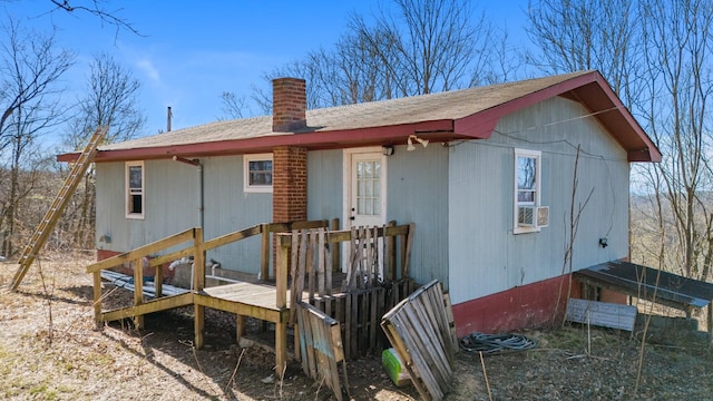 rear view of property with a chimney