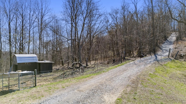 view of street with a gate and a forest view
