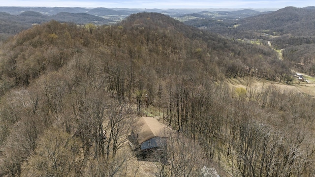 aerial view featuring a view of trees and a mountain view