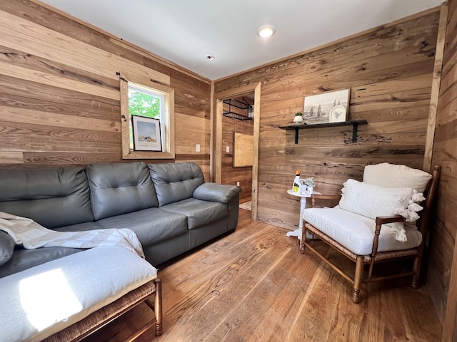 living room featuring recessed lighting, wood walls, and wood finished floors