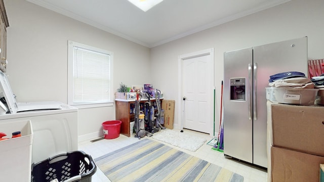 clothes washing area with light floors, baseboards, laundry area, crown molding, and washer and clothes dryer