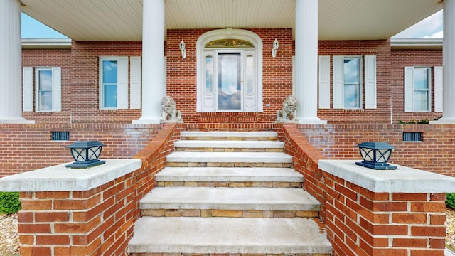 view of exterior entry with brick siding