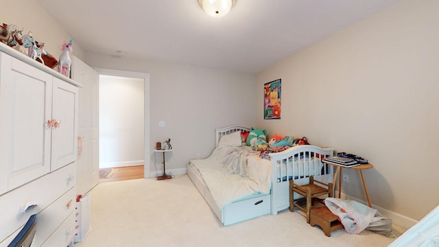 bedroom with carpet and baseboards