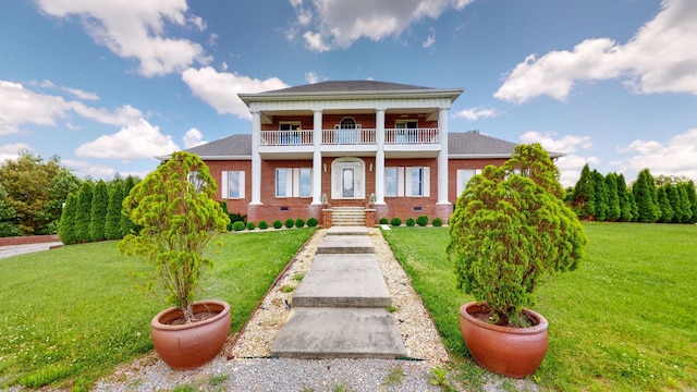 neoclassical / greek revival house featuring brick siding, crawl space, a front lawn, and a balcony