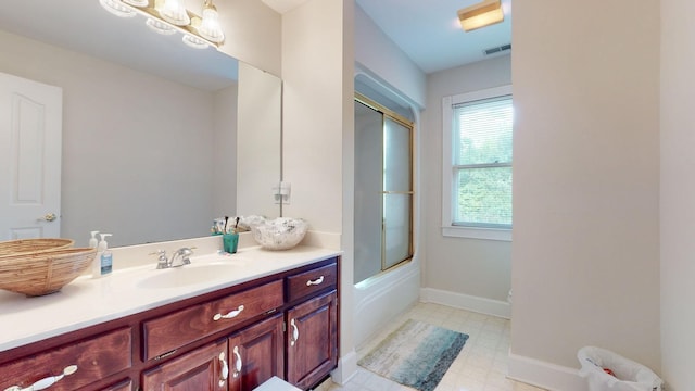 full bathroom featuring visible vents, baseboards, tile patterned floors, vanity, and enclosed tub / shower combo