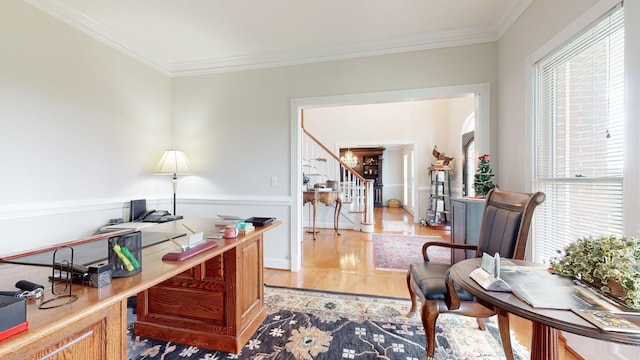 office with light wood-style floors and ornamental molding