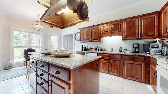 kitchen featuring white appliances, light stone countertops, a center island, backsplash, and a chandelier