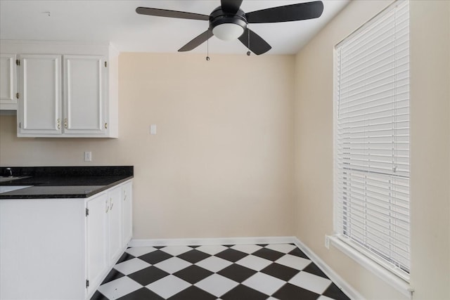 975 General George Patton Rd, Nashville, TN 37221 - kitchen with a ceiling fan, dark countertops, baseboards, white cabinets, and tile patterned floors