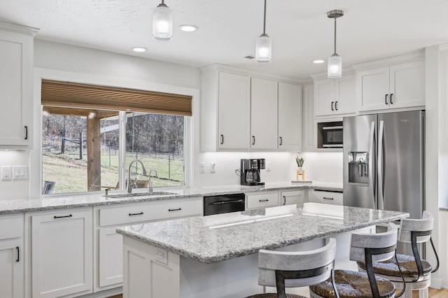 744 Dobbins Pike, Gallatin, TN 37066 - kitchen with a sink, stainless steel fridge with ice dispenser, white cabinets, a kitchen bar, and healthy amount of natural light