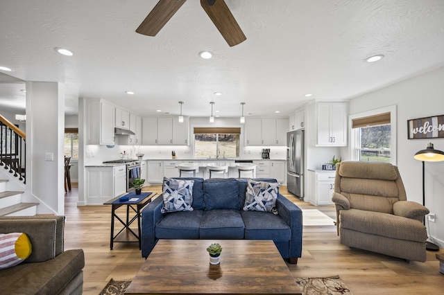744 Dobbins Pike, Gallatin, TN 37066 - living room with plenty of natural light, light wood-style floors, a ceiling fan, stairway, and recessed lighting