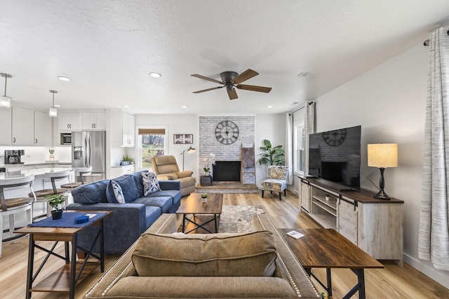 744 Dobbins Pike, Gallatin, TN 37066 - living area featuring a brick fireplace, light wood finished floors, ceiling fan, and recessed lighting