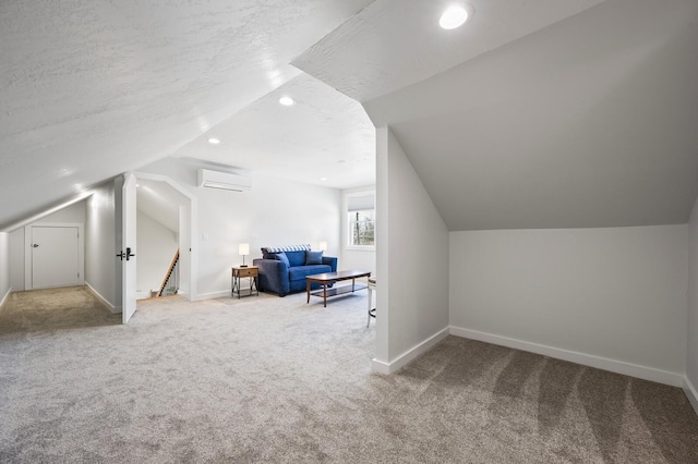 744 Dobbins Pike, Gallatin, TN 37066 - additional living space with a wall mounted AC, carpet flooring, lofted ceiling, baseboards, and recessed lighting