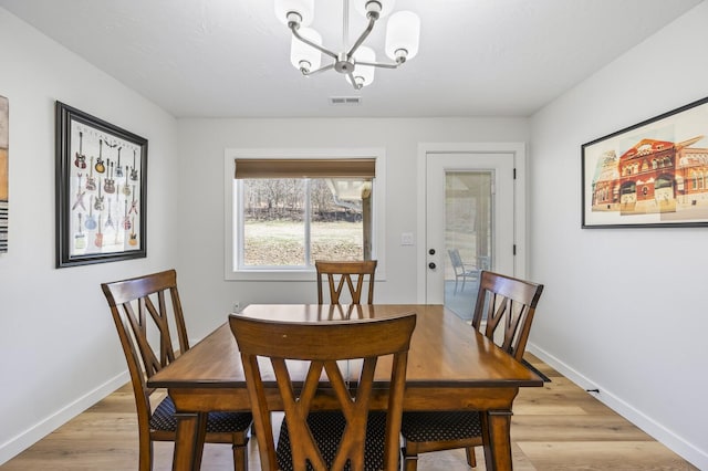 744 Dobbins Pike, Gallatin, TN 37066 - dining space with a chandelier, light wood-style floors, and baseboards