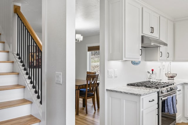 744 Dobbins Pike, Gallatin, TN 37066 - kitchen with gas range, under cabinet range hood, light wood finished floors, and white cabinets