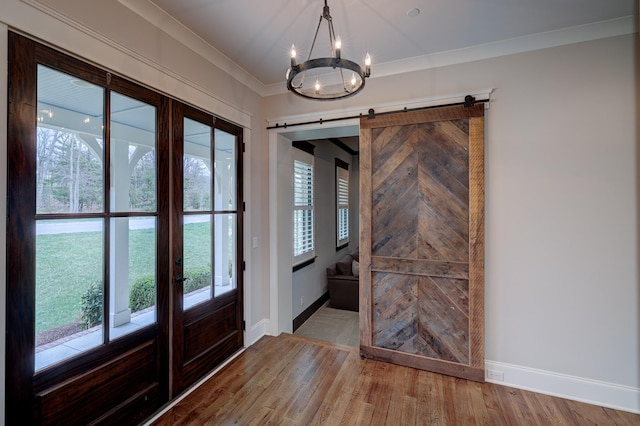 209 Gilchrist S Cir, Nolensville, TN 37135 - foyer entrance with baseboards, a chandelier, wood finished floors, a barn door, and ornamental molding