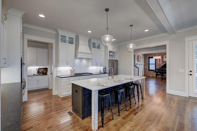 209 Gilchrist S Cir, Nolensville, TN 37135 - kitchen with custom range hood, light wood-style floors, decorative backsplash, ornamental molding, and recessed lighting