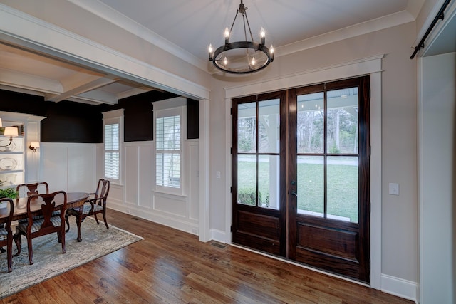 209 Gilchrist S Cir, Nolensville, TN 37135 - entryway featuring a chandelier, wood finished floors, a wainscoted wall, a decorative wall, and healthy amount of natural light