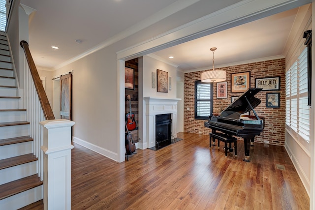 209 Gilchrist S Cir, Nolensville, TN 37135 - living area with brick wall, hardwood / wood-style flooring, plenty of natural light, stairway, and baseboards