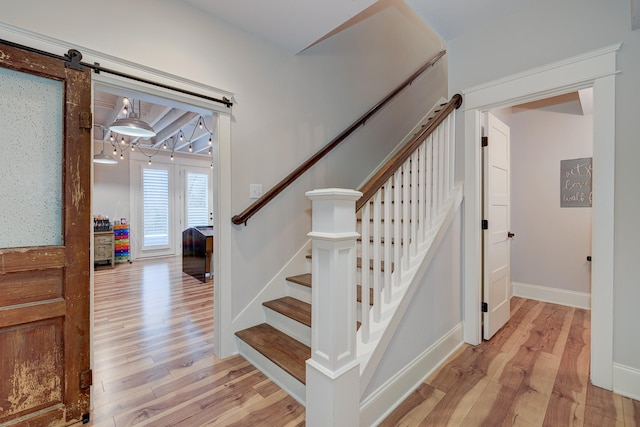 209 Gilchrist S Cir, Nolensville, TN 37135 - staircase featuring wood finished floors, a barn door, and baseboards