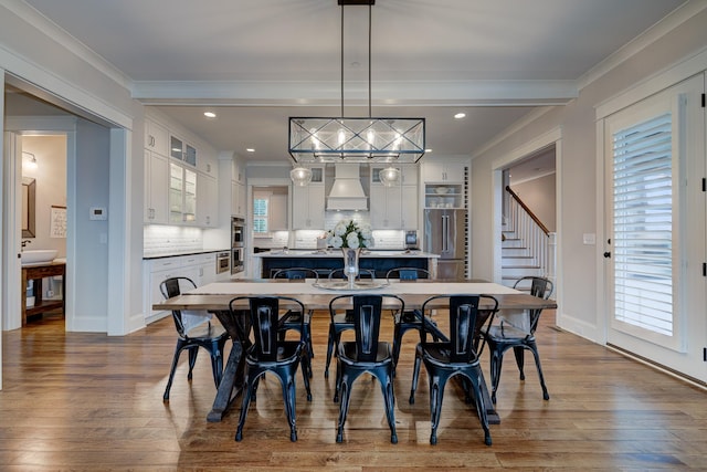209 Gilchrist S Cir, Nolensville, TN 37135 - dining area with wood finished floors, ornamental molding, recessed lighting, baseboards, and stairs