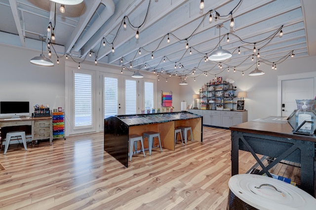 209 Gilchrist S Cir, Nolensville, TN 37135 - kitchen with light wood-style flooring, a kitchen breakfast bar, dark countertops, open floor plan, and a center island