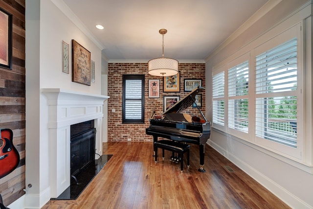 209 Gilchrist S Cir, Nolensville, TN 37135 - sitting room with brick wall, wood-type flooring, ornamental molding, a fireplace, and baseboards