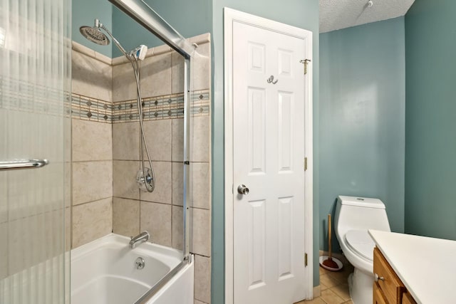 full bathroom with toilet, shower / bath combination, tile patterned floors, a textured ceiling, and vanity