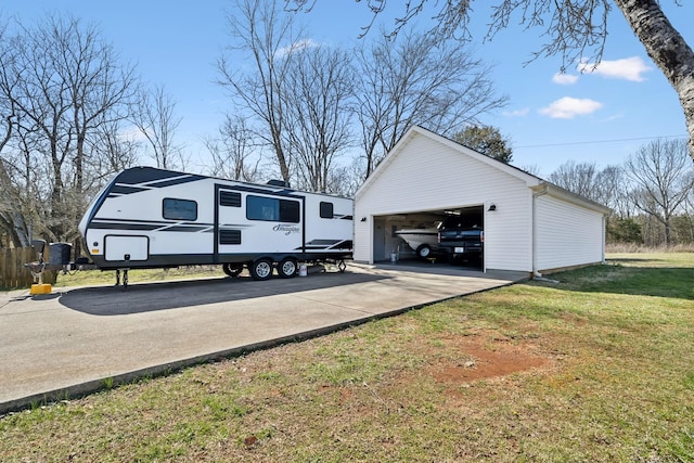 view of side of home featuring an outbuilding, a lawn, and a detached garage