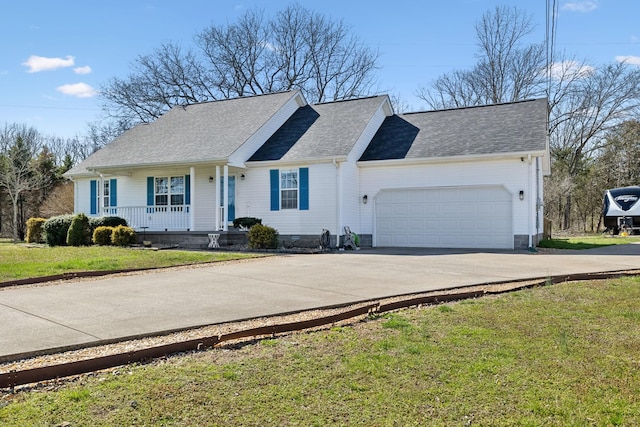 single story home with a porch, an attached garage, driveway, and a front yard