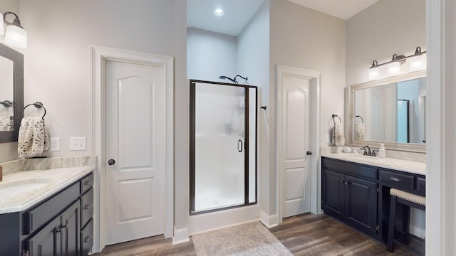 1945 Mann Rd, Lebanon, TN 37087 - full bathroom featuring a stall shower, wood finished floors, two vanities, baseboards, and recessed lighting