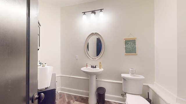1945 Mann Rd, Lebanon, TN 37087 - bathroom with wood finished floors, toilet, and a wainscoted wall