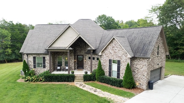 1945 Mann Rd, Lebanon, TN 37087 - craftsman-style house featuring a front lawn, concrete driveway, a garage, and brick siding