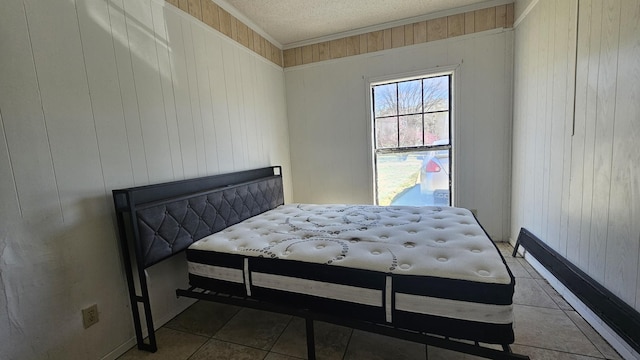 tiled bedroom with wooden walls, a textured ceiling, and ornamental molding