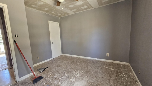 spare room featuring baseboards and ceiling fan