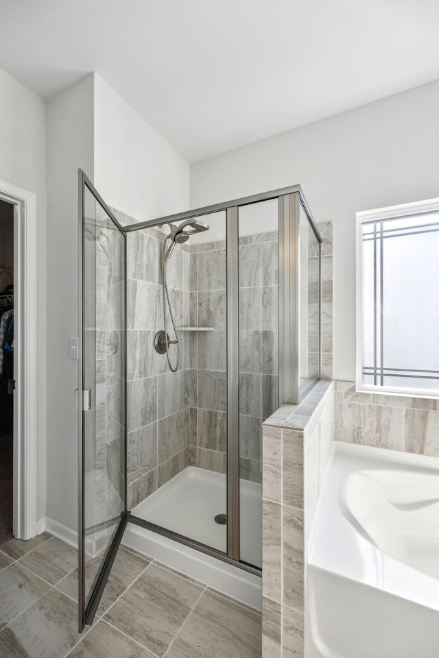 full bath with a garden tub and a stall shower