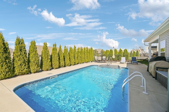 view of swimming pool featuring grilling area, a fenced in pool, a patio, and fence