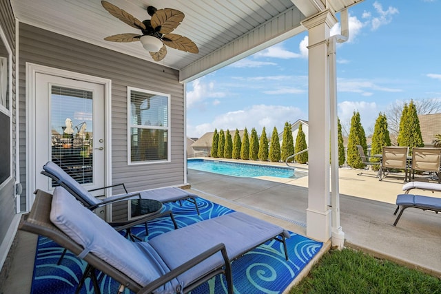 view of patio with an outdoor pool and a ceiling fan
