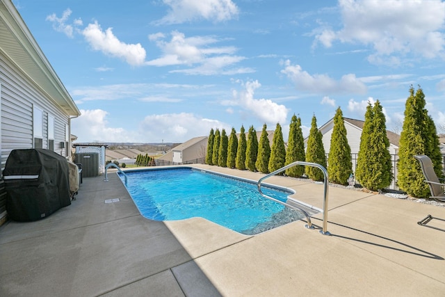 view of pool with a patio area, area for grilling, and a fenced in pool