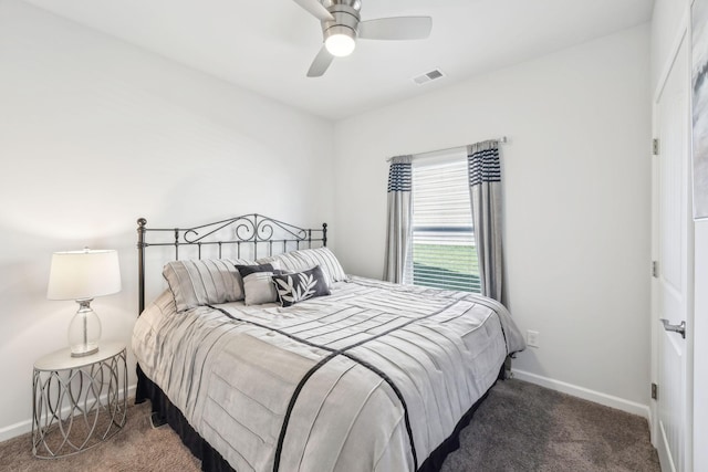 carpeted bedroom featuring visible vents, a ceiling fan, and baseboards