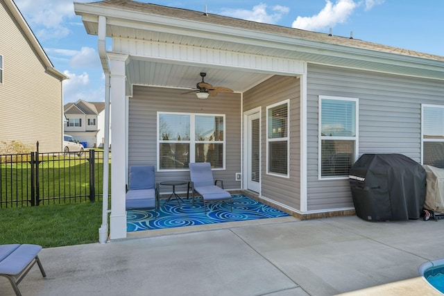 view of patio with grilling area, fence, and ceiling fan